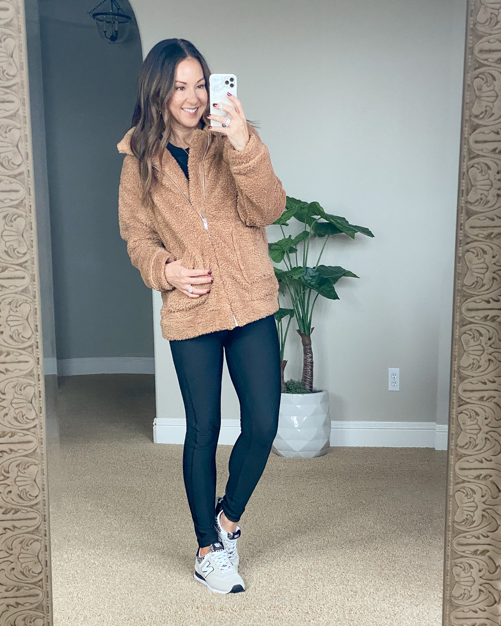 brown sherpa jacket, black leggings with pocket, new balance sneakers 